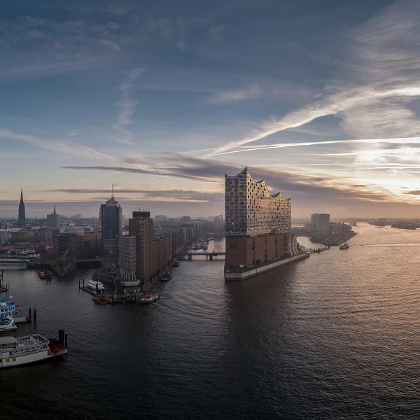 Elbphilharmonie in Hamburg bei Sonnenuntergang, Blick über den Hafen und die Speicherstadt, Himmel mit Lichtstreifen